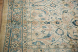 Angled view of the Mahal carpet's border in dusty teal and terracotta with its intact side cord visible.