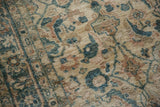 Angled detail of the Mahal carpet's even pile and Herati design in dusty teal.