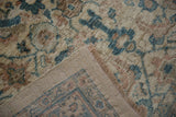 Corner of the Mahal carpet folded over, showing the dense pile and hand-knotted foundation.