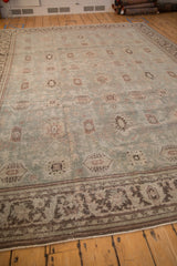 Angled view of a vintage Mahal carpet highlighting its evenly worn texture and geometric motifs.