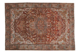 Distressed vintage Ahar carpet with a starburst medallion and floral vines in rust, slate blue, and silver.