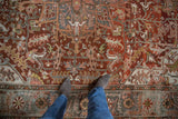 Heavily abrashed pile of a vintage Ahar carpet with sprawling slate blue vines and saffron blossoms.