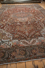 Low angle view along a distressed Ahar carpet, showcasing its abrashed texture and rust palette.