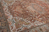Sprawling floral vines in rust, dusty teal, and silver on a vintage Ahar carpet's abrashed field.