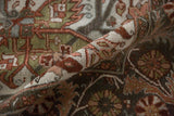 Rolled edge of a distressed Ahar carpet showing the tight, hand-knotted weave in rust and teal.