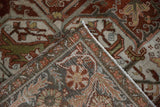 Corner of a vintage Ahar carpet folded to reveal the hand-knotted foundation and worn floral pile.