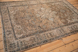 Distressed vintage Isfahan rug detail: worn sand, beige, and blue floral field and border.