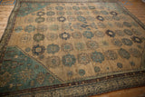 Stepped teal corner spandrel of an antique Persian Malayer carpet with beige field guls.