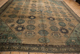 Antique Malayer rug corner: stepped dusty blue spandrel, beige floral guls, and vine boteh border.