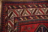 Reciprocating pawn and serrated leaf motifs in the geometric borders of an antique Kazak rug.