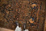 Pictorial hunting scene with lions in a corner of an antique Persian Farahan Sarouk rug.