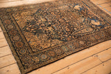 A view across the antique pictorial Farahan Sarouk rug highlighting its dense pattern and formal borders.