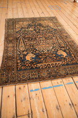 Angled view of an antique Pictorial Farahan Sarouk rug highlighting its intricate hunting scene and borders.