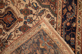 Corner detail of a vintage Malayer rug showing the hand-knotted back and floral pattern on the pile.