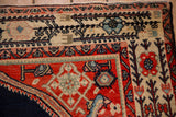 Corner detail of a Malayer carpet's red spandrel and Serbend-inspired main border.