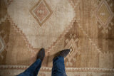 Soft, low pile showing the abrashed coffee brown and sand tones of a vintage Kars carpet.