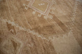 Detailed texture of the short, abrashed pile and hook motifs on a vintage Kars carpet.