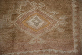 Quatrefoil starburst floral detail in the short, abrashed pile of a vintage Kars carpet.