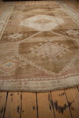 Low angle view highlighting the short pile and abrashed texture of the vintage Kars carpet.