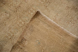 Vintage distressed Kars carpet corner, showing secured selvage and woven foundation with blue marks.