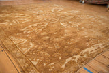 Angled view across the soft, short pile of a distressed vintage Kars carpet in neutral tones.