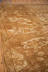 The short pile and detailed floral arabesque border on a vintage Kars carpet.