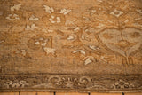 Low, hand-knotted pile texture on a distressed Kars rug in sand and coffee brown tones.