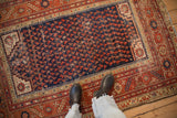 Antique Malayer rug, navy field of staggered red botehs, brick red borders, even pile wear.