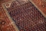 Antique Persian Malayer rug's navy field with staggered brick red boteh motifs and visible foundation wear.