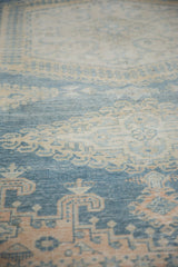 Angled view highlighting the distressed low pile and color abrashes of a vintage Veece carpet.