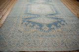Distressed vintage Veece carpet viewed down its length, showcasing soft abrashes in the blue and ivory pile.