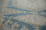 Low pile texture showing even wear and knot heads on a distressed vintage Veece carpet.