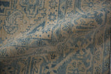 A soft fold reveals the distressed texture and hand-knotted weave of a vintage Veece carpet.