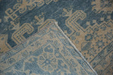 Hand-knotted foundation and machine-bound side of a vintage distressed Veece carpet.
