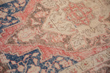 Distressed pile texture of ivory, cobalt blue, and sandalwood tones on this vintage Oushak rug.