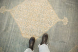 Distressed vintage Tabriz rug: hexagonal Herati medallion on abrashed dusty blue with ivory and saffron.