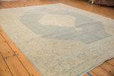 Worn pile of vintage distressed Tabriz carpet, featuring palmette border and abrashed blues.