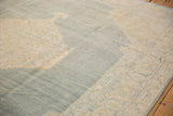 Distressed Tabriz carpet with an abrashed dusty denim blue field and ivory floral spandrel.