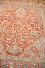 Low-angle view showing the geometric relief and textured pile of a distressed Baktiari rug.