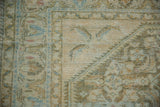 Textural detail of vintage distressed Hamadan rug, showing worn pile with soft beige, blue, and green.