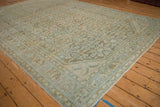 Corner detail of distressed vintage Hamadan carpet, showcasing faded Herati and scrolled palmette designs.