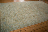 Distressed texture and faded Herati design in a vintage Hamadan carpet corner.