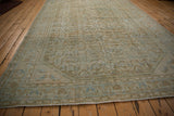 Distressed vintage Hamadan carpet with worn Herati pattern, machine-bound edge, and fringe.