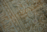 Distressed Hamadan carpet texture, featuring muted Herati motif in beige, blue, and sage.