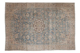 Distressed vintage Tabriz carpet with a central roundel medallion, scrolling vines, and birds in dusty blue and ivory.