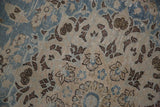 Distressed vintage Tabriz carpet pile with delicate floral patterns in dusty blue and brown.