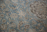 Delicately drawn floral motifs on the distressed, low pile of a vintage Tabriz carpet.