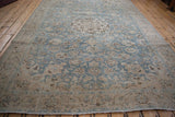 Full length view of the distressed vintage Tabriz carpet's decorative blue and ivory pattern.