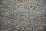 Angled view of the distressed low pile showing the knot heads and floral patterns of the Tabriz carpet.
