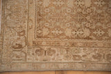 Corner detail of a vintage Bijar rug with a distressed low pile and Herati border.